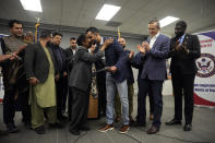 U.S> Rep. Sheila Jackson Lee, D-Texas, center left, hugs Abdul Wasi Safi, after presenting him a certificate during a news conference Friday, Jan. 27, 2023, in Houston. Wasi Safi, an intelligence officer for the Afghan National Security Forces who fled Afghanistan following the withdrawal of U.S. forces, was freed this week and reunited with his brother after spending months in immigration detention. (AP Photo/David J. Phillip)