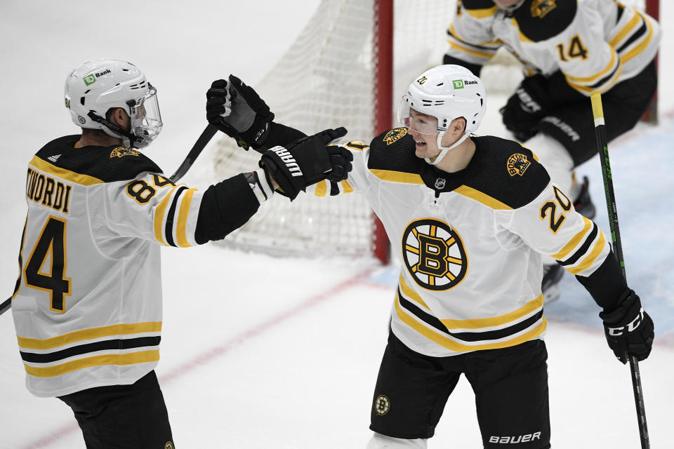 Boston Bruins center Curtis Lazar (20) celebrates his goal with defenseman Jarred Tinordi (84) during the second period of an NHL hockey game against the Washington Capitals, Tuesday, May 11, 2021, in Washington. (AP Photo/Nick Wass)