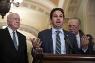 Sen. Patrick Leahy, D-Vt., left, and Senate Minority Leader Chuck Schumer of N.Y., right, listen as Sen. Brian Schatz, D-Hawaii, speaks about the coronavirus, Tuesday, March 3, 2020 in Washington. (AP Photo/Alex Brandon)