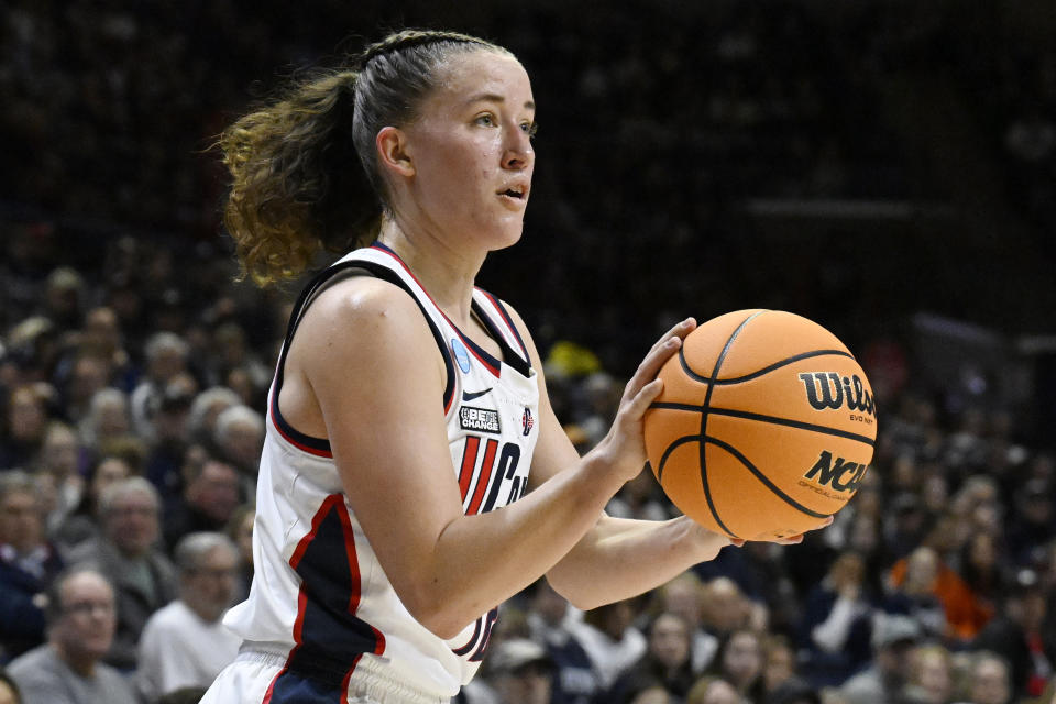 UConn guard Ashlynn Shade lines up a 3-point basket in the first half of a second-round college basketball game against Syracuse in the NCAA Tournament, Monday, March 25, 2024, in Storrs, Conn. (AP Photo/Jessica Hill)