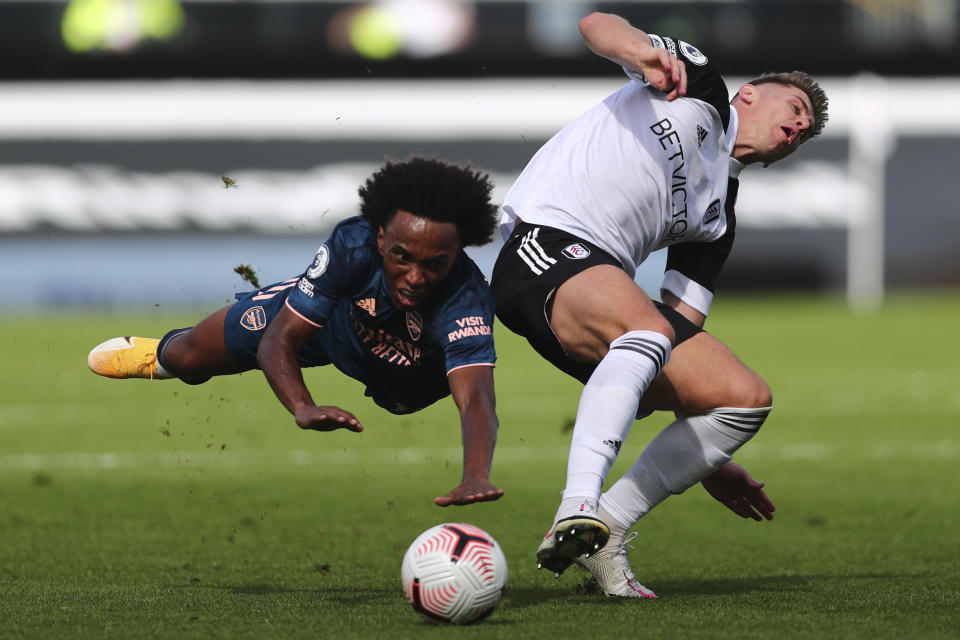 Arsenal's Willian, left, and Fulham's Tom Cairney vie for the ball during the English Premier League soccer match between Fulham and Arsenal in London, Saturday, Sept.12, 2020. (Clive Rose/Pool via AP)