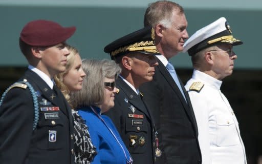 US Army General David Petraeus (3rd R) with his family, including children Stephen (L) and Anne (2nd L), and wife Holly (3rd L), as well as Admiral Mike Mullen (R) and Deputy Secretary of Defense William Lynn (2nd R), during an Armed Forces Farewell Tribute and Retirement Ceremony in honor of Petraeus in Arlington, Virginia, in 2011