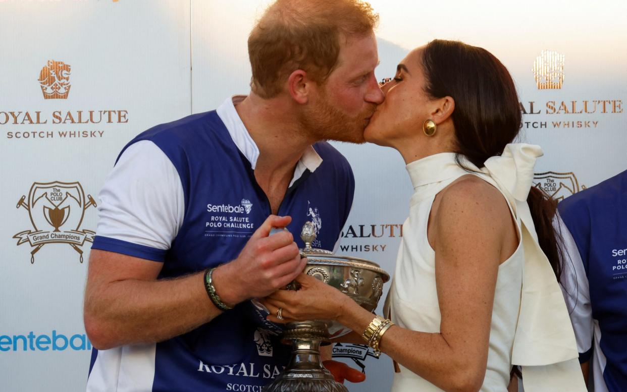 The Duchess of Sussex presented Prince Harry with the trophy after the match