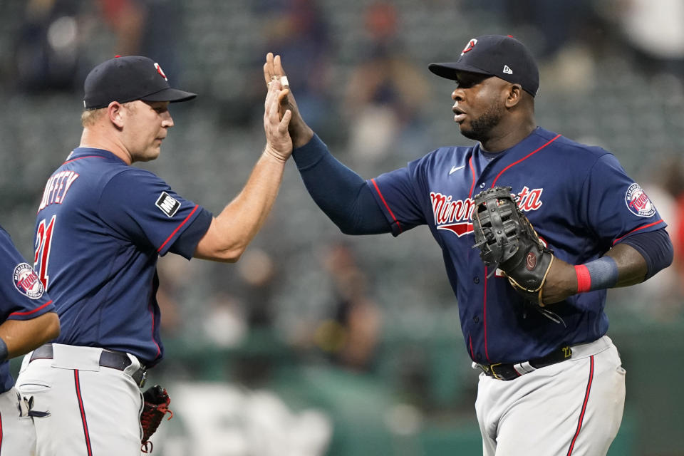 Minnesota Twins' Miguel Sano, right, celebrates with relief pitcher Tyler Duffey after the Twins defeated the Cleveland Indians 3-0 in a baseball game Wednesday, Sept. 8, 2021, in Cleveland. (AP Photo/Tony Dejak)
