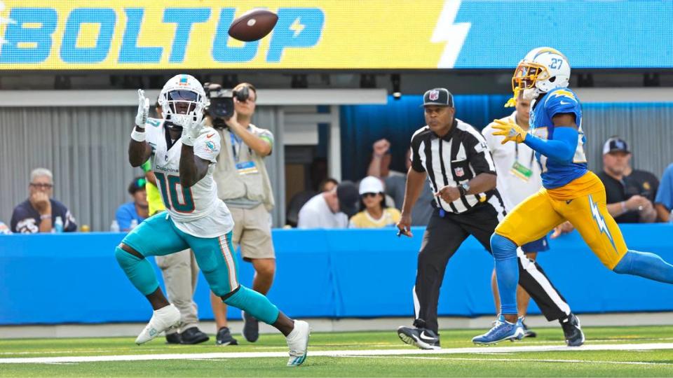 Miami Dolphins wide receiver Tyreek Hill (10) catches a long bomb as Los Angeles Chargers cornerback J.C. Jackson (27) fails to defend in the second half at SoFi Stadium in Inglewood, California on Sunday, September 10, 2023.
