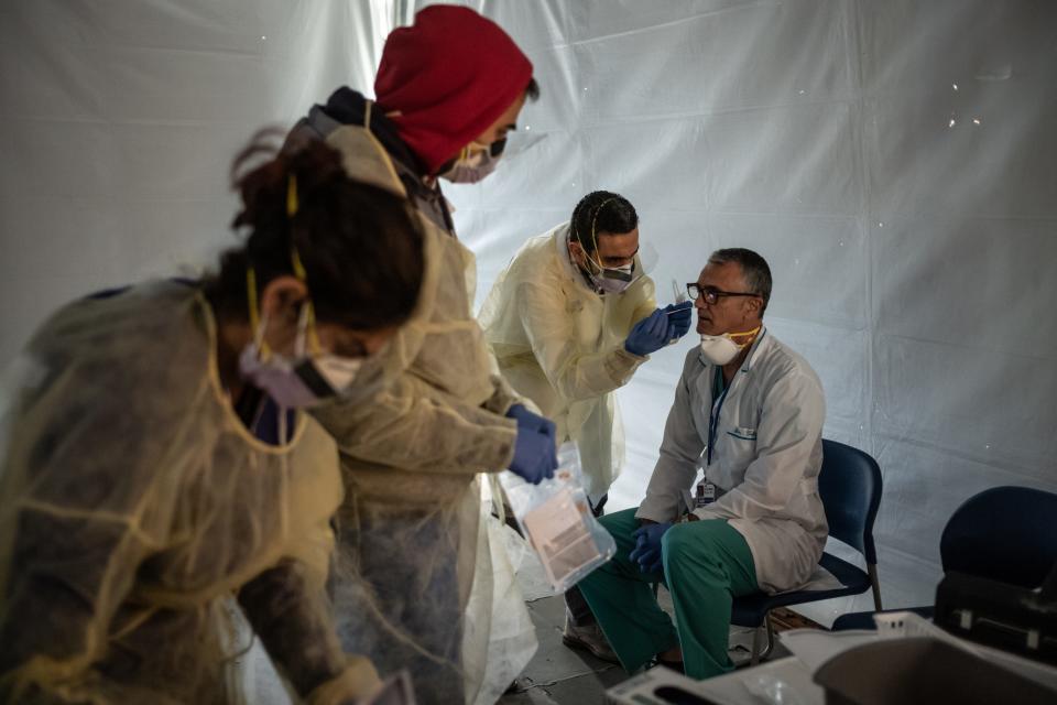 Doctors test hospital staff with flu-like symptoms for coronavirus (COVID-19) in tents set up to triage possible COVID-19 patients before they enter the main emergency department at St. Barnabas hospital in the Bronx on March 24 in New York City.