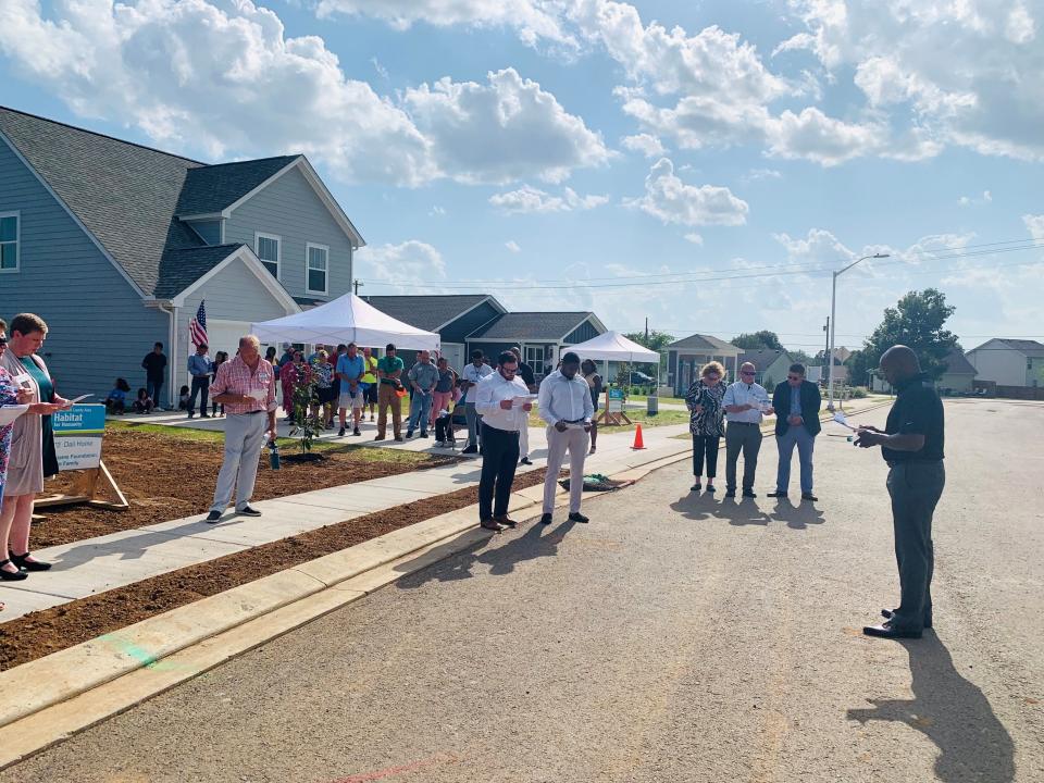 The Rev. James McCarroll, pastor at First Baptist Church, East Castle in Murfreesboro, prayers over the newly dedicated homes in Rutherford County Habitat for Humanity's Legacy Pointe subdivision on July 15, 2021.