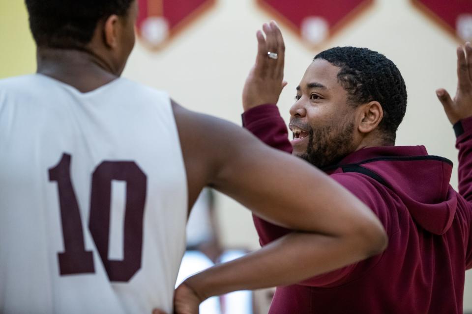 Lutheran Saints head boys basketball coach Remus Woods demonstrates what he'd like to see defensively from his 6 foot, 5 inch sophomore power forward Kameron Patterson during practice Monday, Feb. 22, 2021, in preparation state tournament. "I think we went 6-1 in the conference," Woods said. "So, pretty good for the only 1A school that's in the conference."