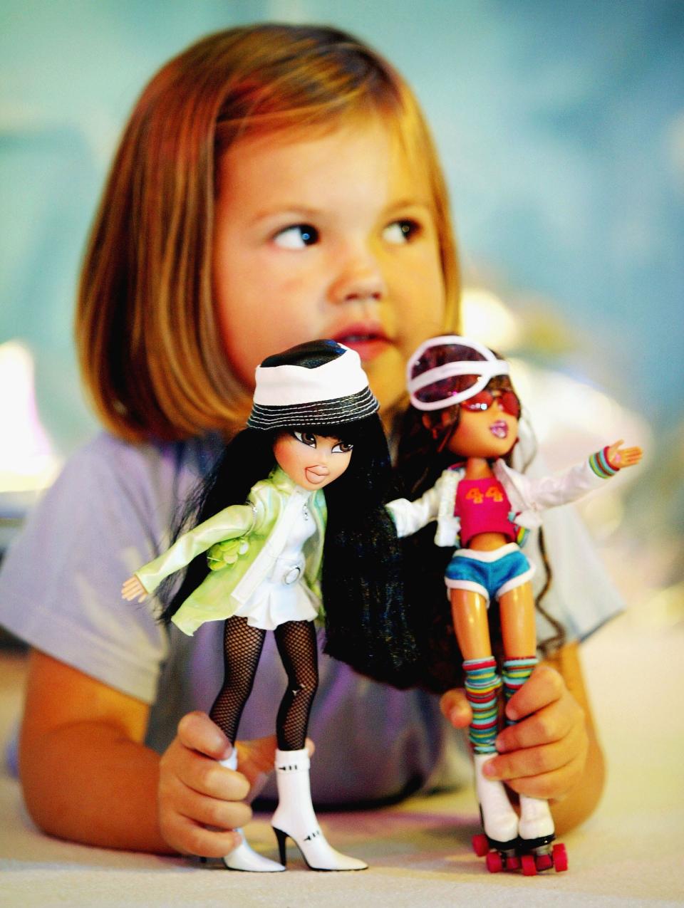 A girl plays with her Bratz dolls in 2004.