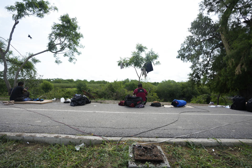 Migrants get electricity from an illegal makeshift connection for their tents on the bank of the Rio Grande in Matamoros, Mexico, Sunday, May 14, 2023. As the U.S. ended its pandemic-era immigration restrictions, migrants are adapting to new asylum rules and legal pathways meant to discourage illegal crossings. (AP Photo/Fernando Llano)