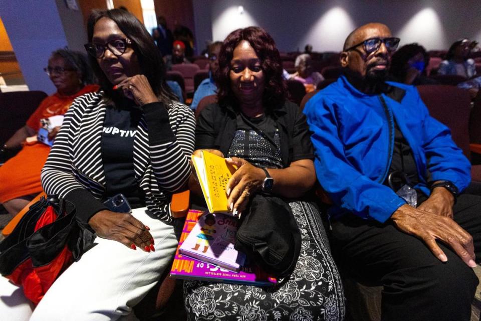 Mildred Moore, center, holds a copy of Amanda Gorman’s poem, ‘The Hill We Climb’ during a town hall regarding the state’s newly adopted curriculum standards on Black history at Antioch Missionary Baptist Church in Miami Gardens, Florida, on Thursday, Aug. 10, 2023. The Bob Graham Education Center in Miami Lakes removed the poem from its elementary school library shelves after a parent complained about it.