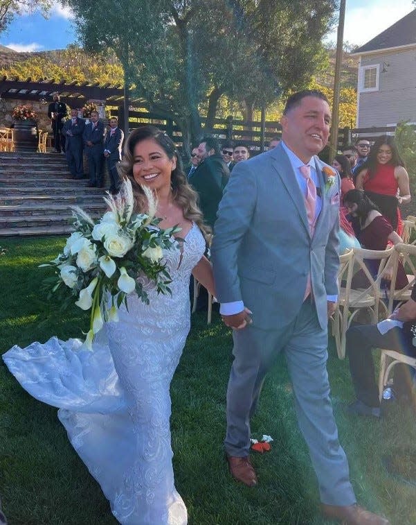 Robert and Rosa Aguilar smile after exchanging wedding vows in Camarillo, California on Oct. 1, 2022, five years to the day after the couple survived the worst mass shooting in U.S. history.