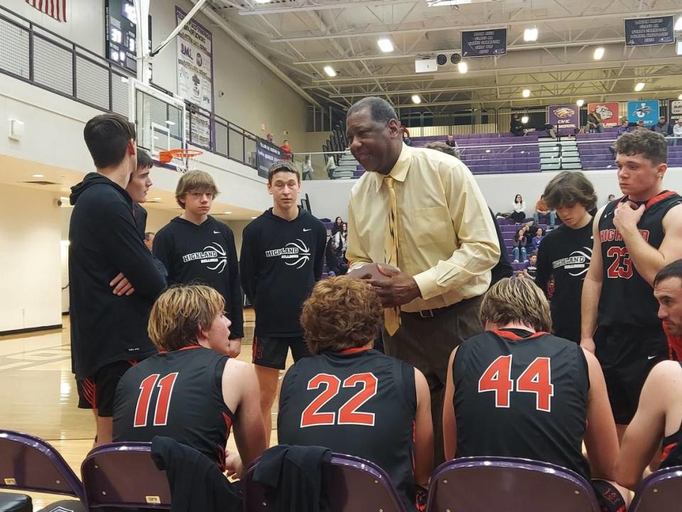 Highland basketball coach Deryl Cunningham discusses strategy with his team during a time out in the fourth quarter of the Bulldogs road game at Mascoutah High School on Friday, Dec. 2. Highland battled hard but ultimately dropped a 57-53 verdict.