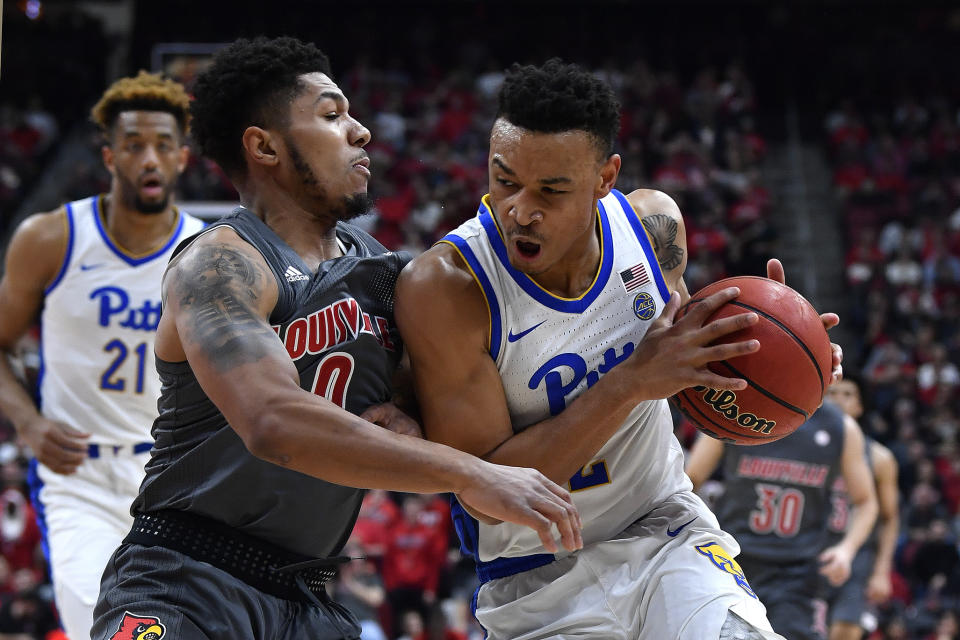 Pittsburgh guard Trey McGowens (2) attempts to drive through the defense of Louisville guard Lamarr Kimble (0) during the first half of an NCAA college basketball game in Louisville, Ky., Friday, Dec. 6, 2019. (AP Photo/Timothy D. Easley)