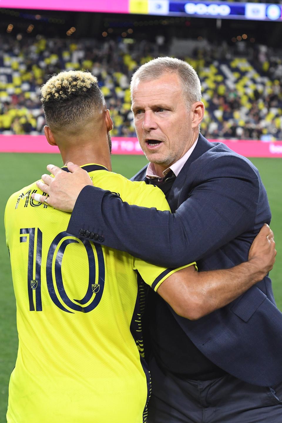 May 6, 2023; Nashville, Tennessee, USA; Nashville SC midfielder Hany Mukhtar (10) and Nashville SC head coach Gary Smith celebrate their victory at the end of their game against the Chicago Fire at Geodis Park. Mandatory Credit: Christopher Hanewinckel-USA TODAY Sports