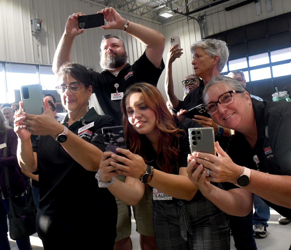 Employees gather to take photos as the ribbon is cut for the official opening of Costco Wholesale in Jackson Township.