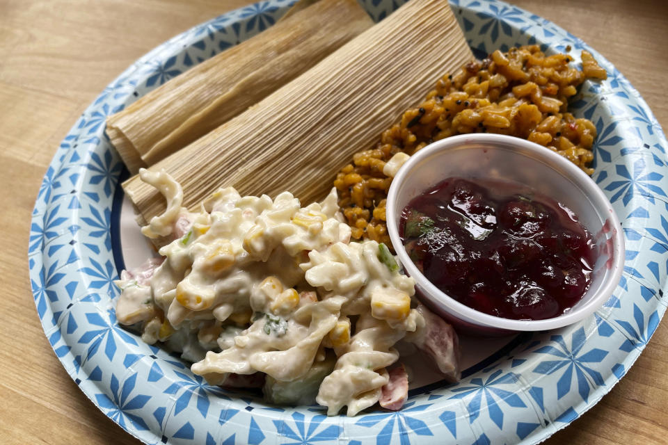 Turkey tamales with cranberry-infused masa and cranberry sauce, Spanish rice with quinoa, and elote pasta salad with chickpea noodles: this contemporary Indigenous meal crafted from a fusion of Southwestern and Northern Native American food traditions was prepared by chef Jessica Pamonicutt at the American Indian Center of Chicago for a senior luncheon on Aug. 3, 2022. (Claire Savage/Report for America via AP)