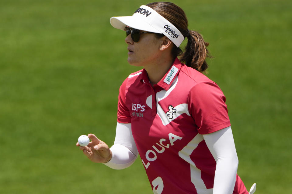 Hannah Green, of Australia, holds up her ball after sinking her putt on the first green during the final round of the Mizuho Americas Open golf tournament, Sunday, May 19, 2024, in Jersey City, N.J. (AP Photo/Seth Wenig)