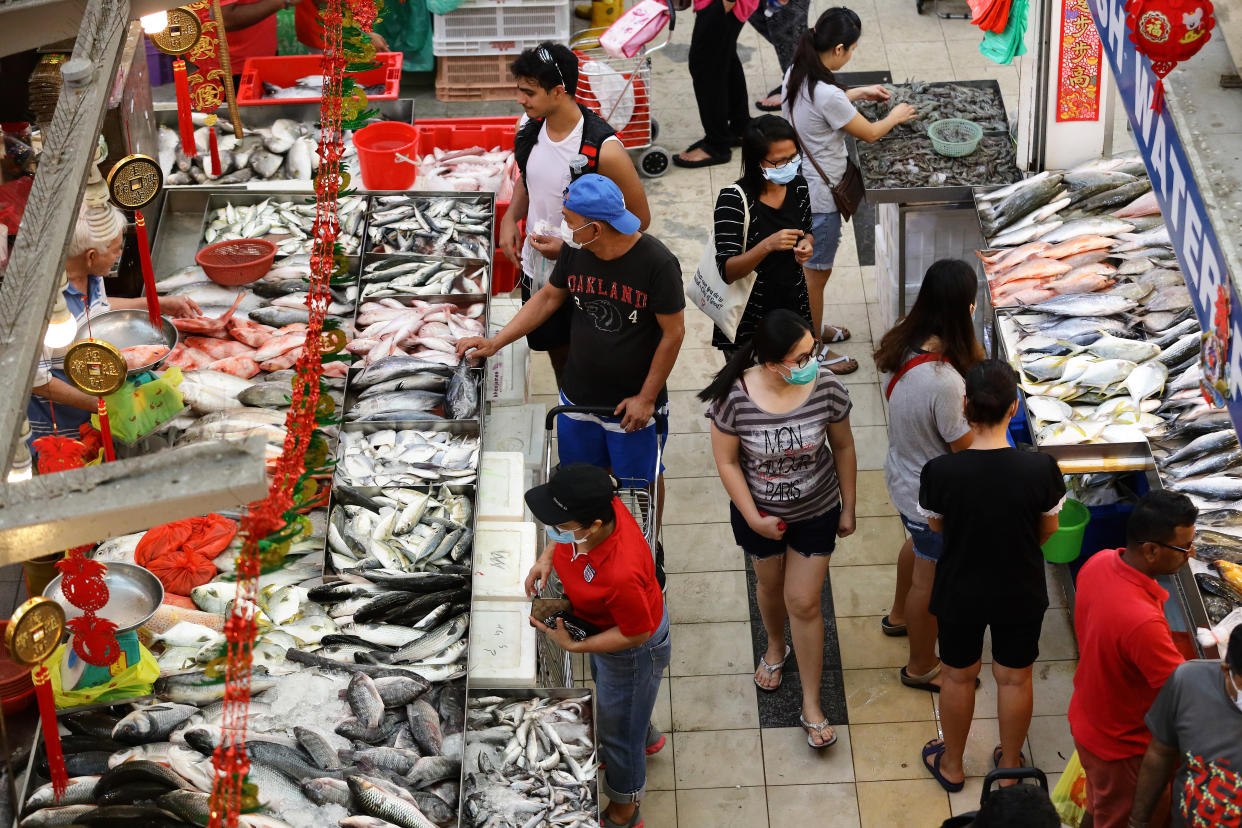 People seen shopping for seafood at a wet market on 28 March 2020. (PHOTO: Getty Images)