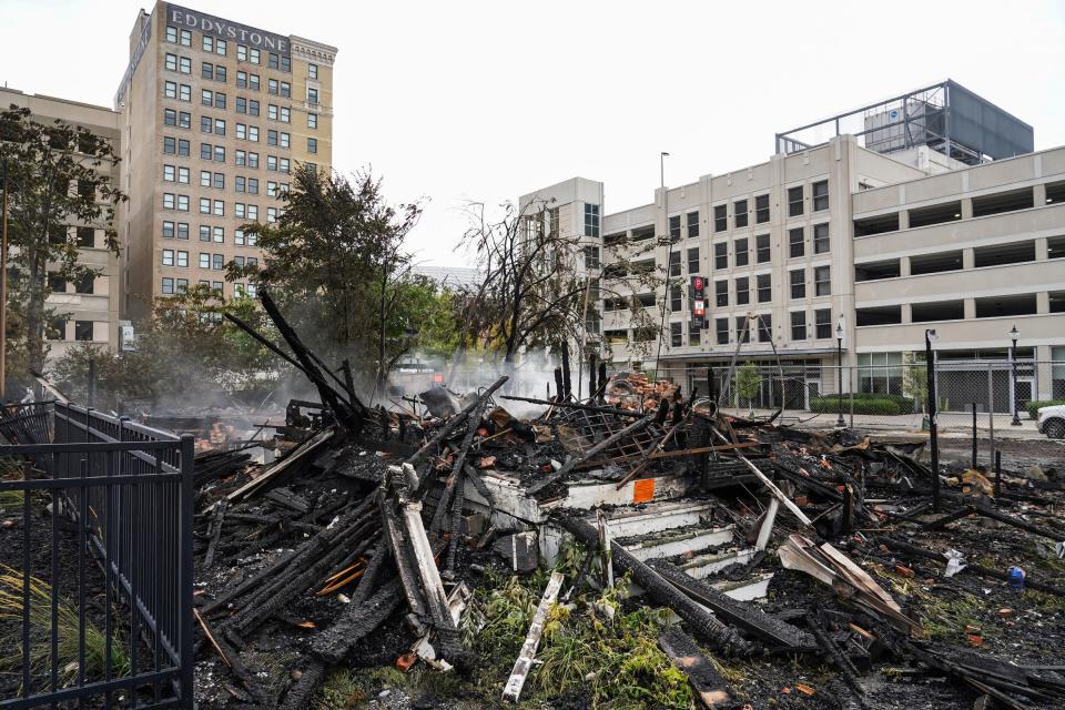 Smoke continues at the remains after an early Monday morning fire destroyed the two-story wood house, at 2712 Cass Ave. in Detroit, whose owner is one of the last arena district "holdouts" who has not sold their property to the Ilitch family organization on Monday, August 8. 2022.