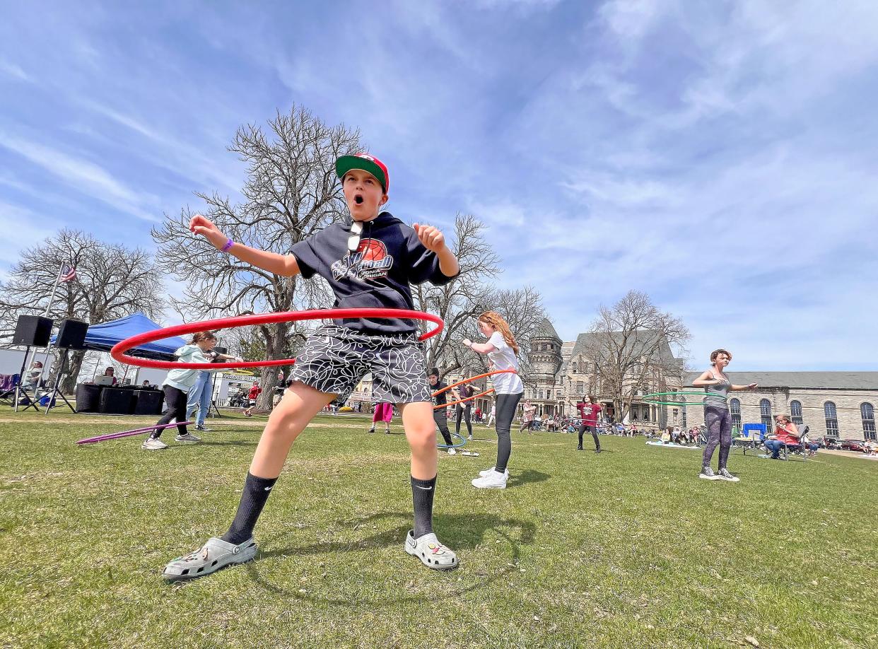 Ethan Blasius , 11, of Westland, Michigan, competes in a Hula Hoop contest outside the Ohio Reformatory on Monday during the festivities before the total solar eclipse.