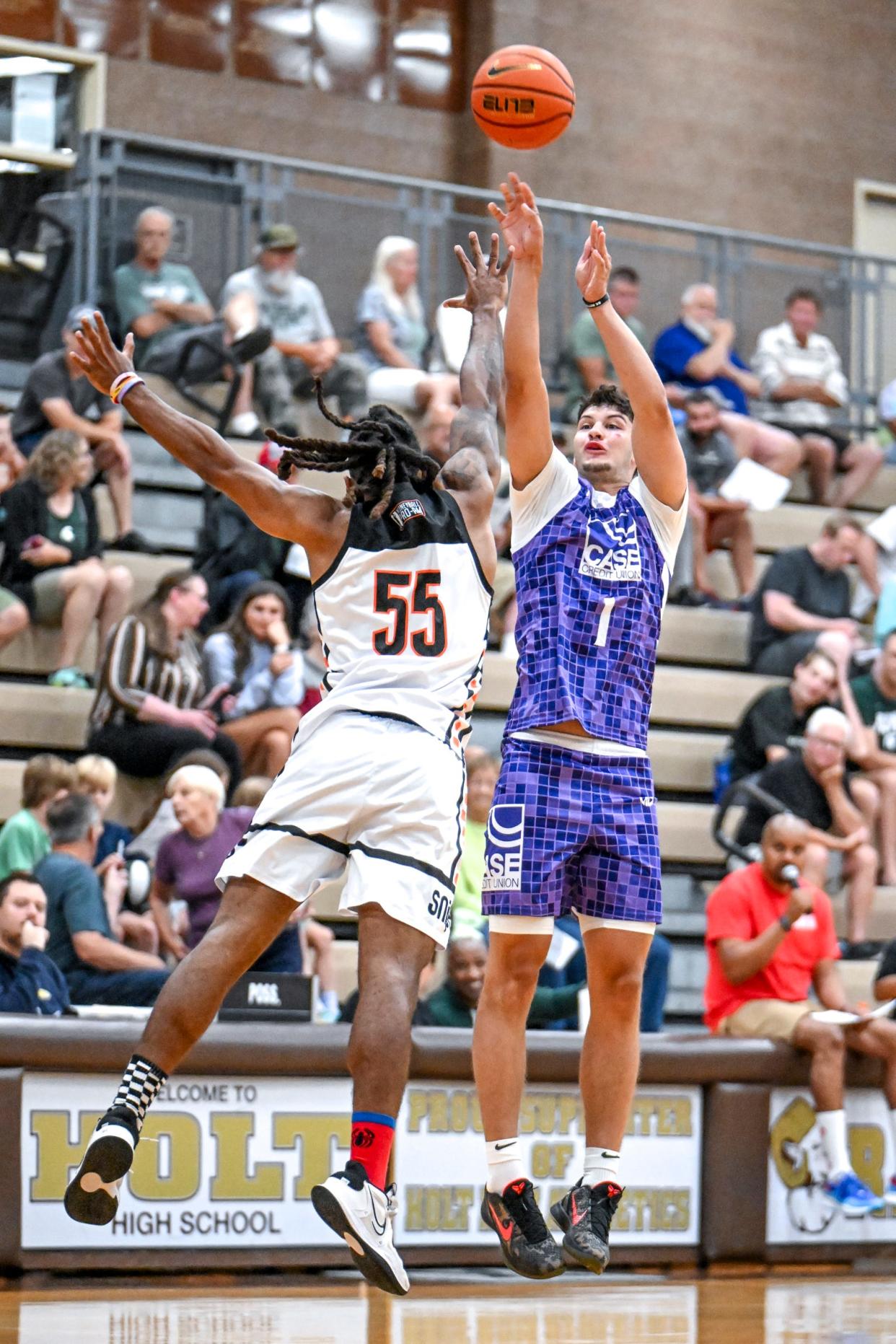 Team Case Credit Union and Michigan State's Frankie Fidler, right, shoots a 3-pointer against Team Snipes in the game on Tuesday, July 9, 2024, during the Moneyball Pro-Am at Holt High School.