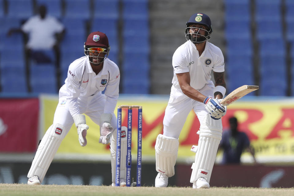 India's captain Virat Kohli eyes the ball after playing a shot to be caught by West Indies' John Campbell during day four of the first Test cricket match at the Sir Vivian Richards cricket ground in North Sound, Antigua and Barbuda, Sunday, Aug. 25, 2019. (AP Photo/Ricardo Mazalan)