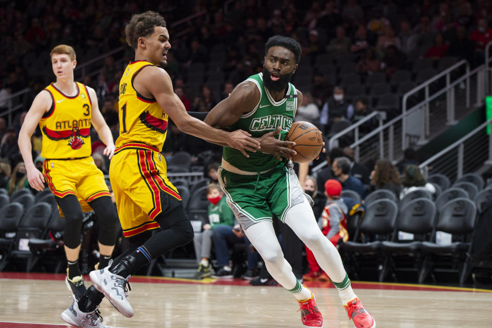 Boston Celtics guard Jaylen Brown (7) drives past Atlanta Hawks guard Trae Young (11) during the first half of an NBA basketball game Friday, Jan. 28, 2022, in Atlanta. (AP Photo/Hakim Wright Sr.)