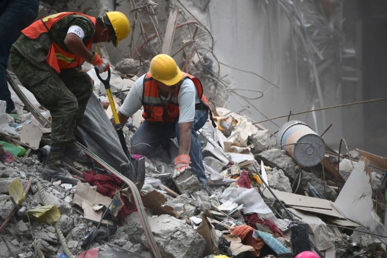 Rescue workers and volunteers in Mexico City search for survivors in a building toppled by a 7.1 magnitude earthquake