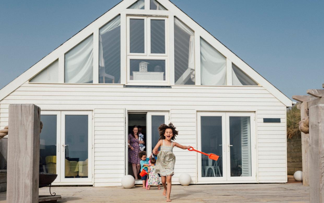 young family exiting vacation home