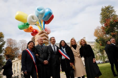 American artist Jeff Koons poses with Mayor of Paris Anne Hidalgo after the unveiling of his sculpture Bouquet of Tulips near the Petit Palais museum in Paris