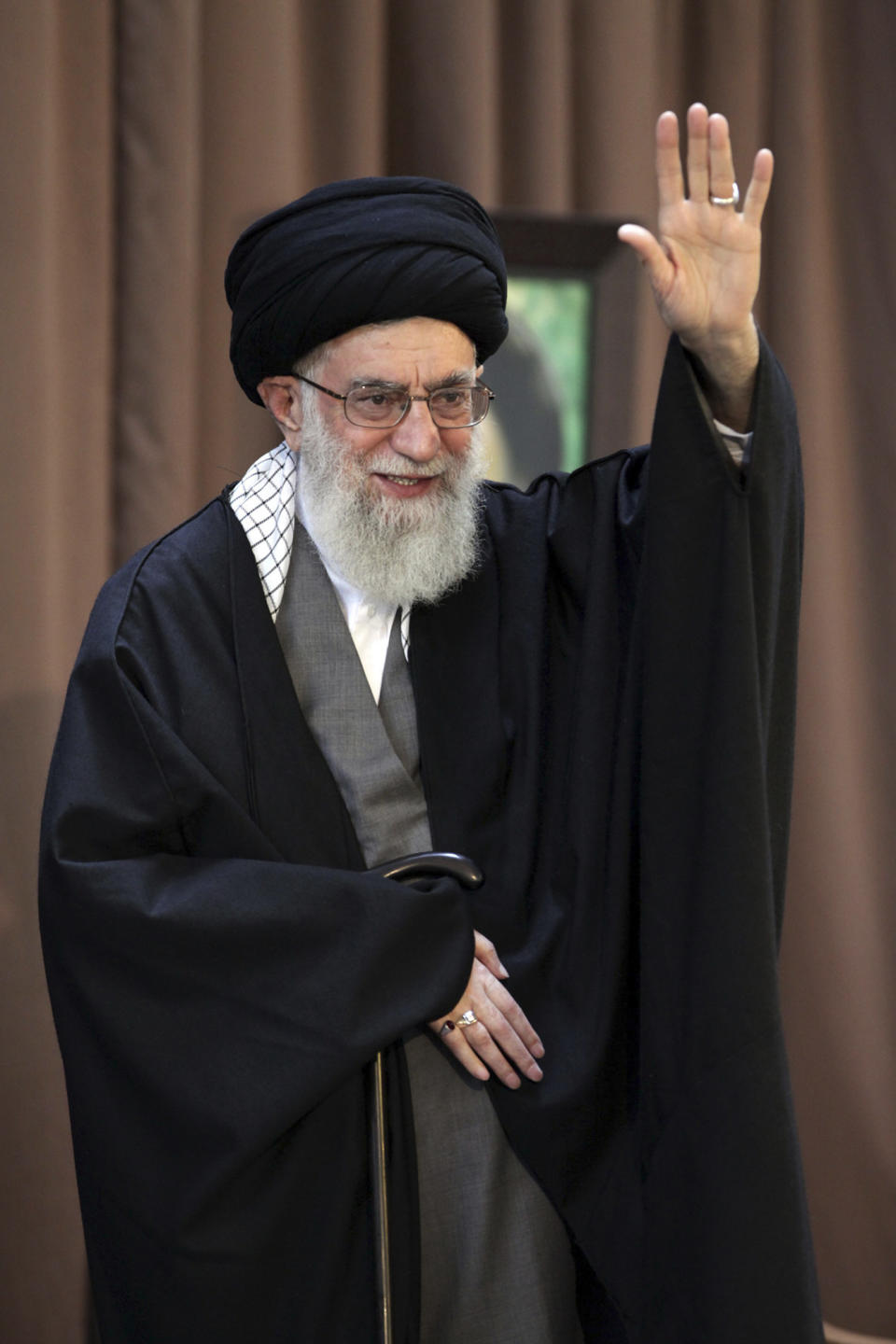 In this picture released by an official website of the office of the Iranian supreme leader, Supreme Leader Ayatollah Ali Khamenei, waves to the audience before giving a speech at a public gathering in the city of Mashhad, Iran, Friday, March 21, 2014. Iran's top leader says his nation can best counter sanctions imposed by the West by strengthening its economy. Khamenei said Iranians should not wait for the sanctions to be lifted but work to build a stronger economy to "reduce vulnerability." (AP Photo/Office of the Iranian Supreme Leader)