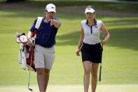 Albane Valenzuela, of Switzerland, and her brother and caddy, Alexis Valenzuela, walk across the 11th green during a practice round prior to the women's golf event at the 2020 Summer Olympics, Monday, Aug. 2, 2021, at the Kasumigaseki Country Club in Kawagoe, Japan. (AP Photo/Matt York)