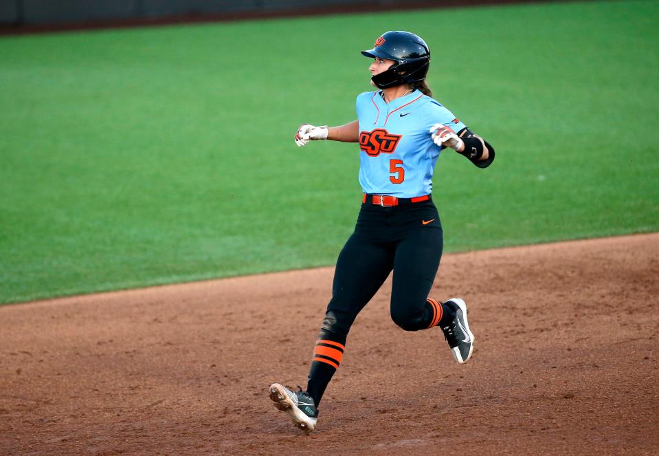 Oklahoma State's Kiley Naomi (5) run into second for a double in the sixth inning during a college softball game between the Oklahoma State Cowgirls and the UT Arlington Mavericks, Wednesday, April, 12, 2023. 