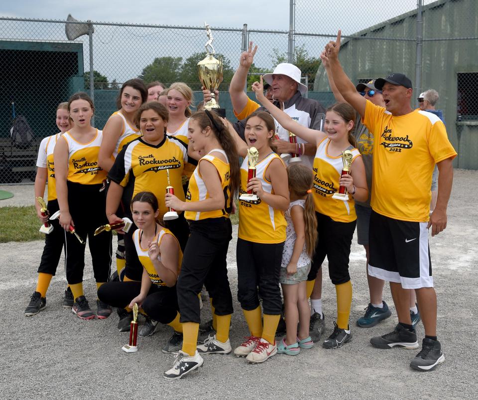 South Rockwood celebrates after winning the Monroe County Fair Softball Tournament last summer. Coach Steve Drummonds' team will bid for its third consecutive title beginning Sunday.