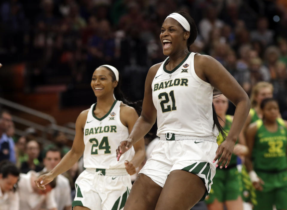Baylor center Kalani Brown (21) and guard Chloe Jackson (24) celebrate after defeating Oregon in a women's Final Four NCAA college basketball semifinal tournament game Friday, April 5, 2019, in Tampa, Fla. (AP Photo/Chris O'Meara)