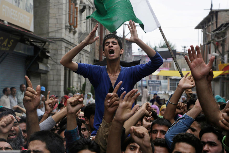 <p>Neighbors and relatives of Irfan Ahmed Wani, who died late Sunday after being hit by a tear gas shell, shout anti-India slogans as they protest his death in Srinagar, Indian-controlled Kashmir, Monday, Aug. 22, 2016. Security lockdown and protests continued with tens of thousands of Indian armed police and paramilitary soldiers patrolling the tense region after the killing of a popular rebel commander on July 8 sparked some of Kashmir’s largest protests against Indian rule in recent years. (AP Photo/Mukhtar Khan) </p>