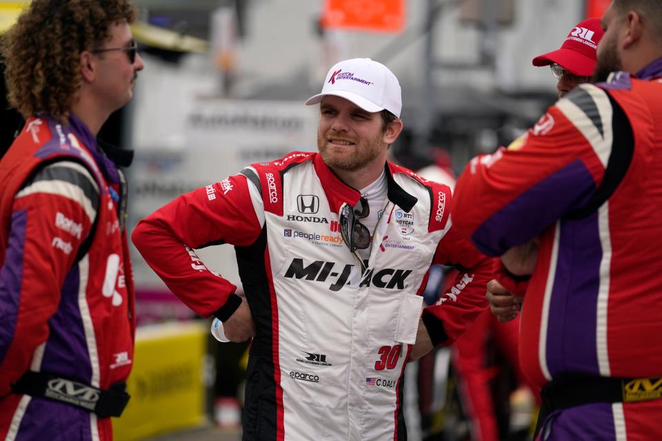 Conor Daly talks with crew members before the start of an IndyCar auto race at World Wide Technology Raceway, Sunday, Aug. 27, 2023, in Madison, Ill.