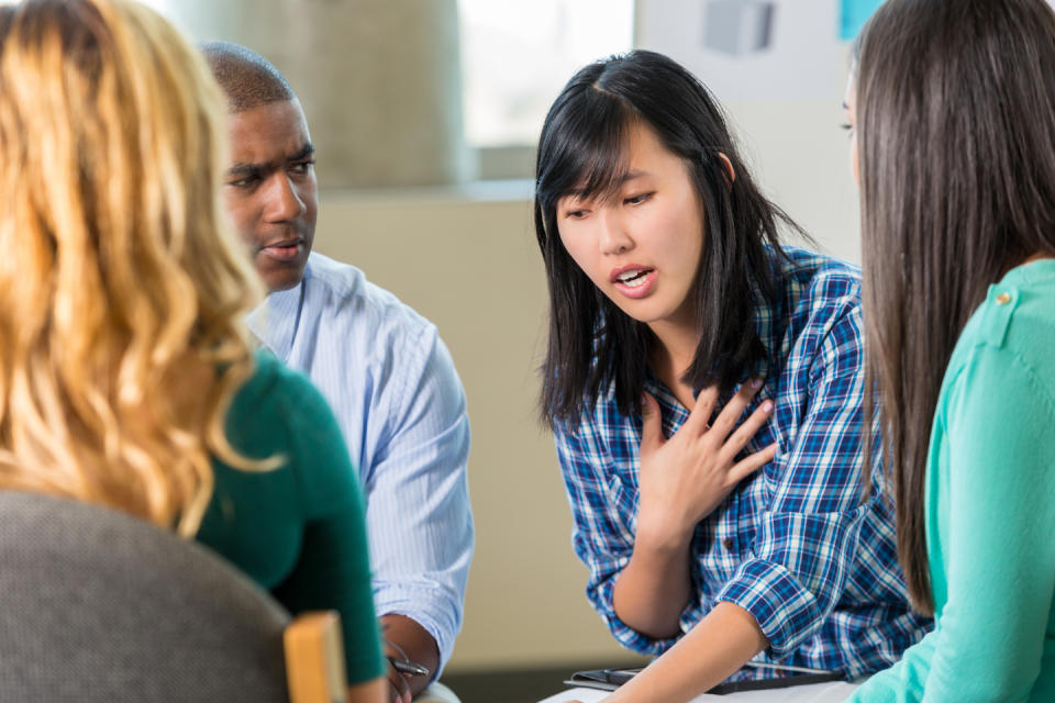 An Asian woman caregiver sharing and getting emotional support in a group setting