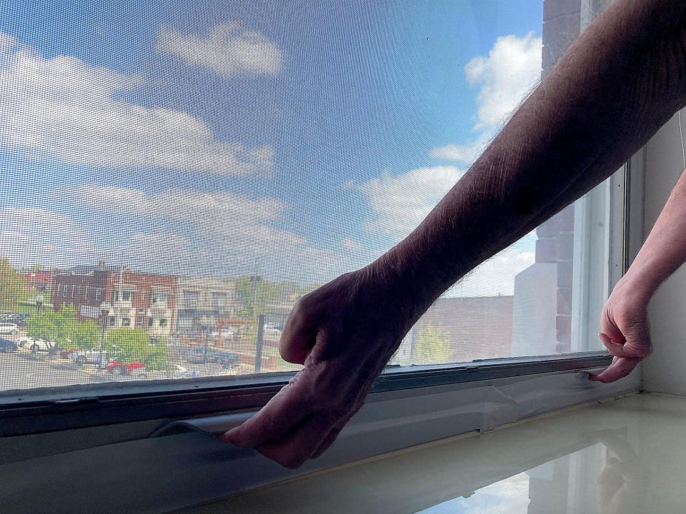 An Essex House resident tries to open their apartment window that does not open and the building's central air conditioning is not working on Wednesday, April 26, 2023. TOM E. PUSKAR/ASHLAND TIMES-GAZETTE