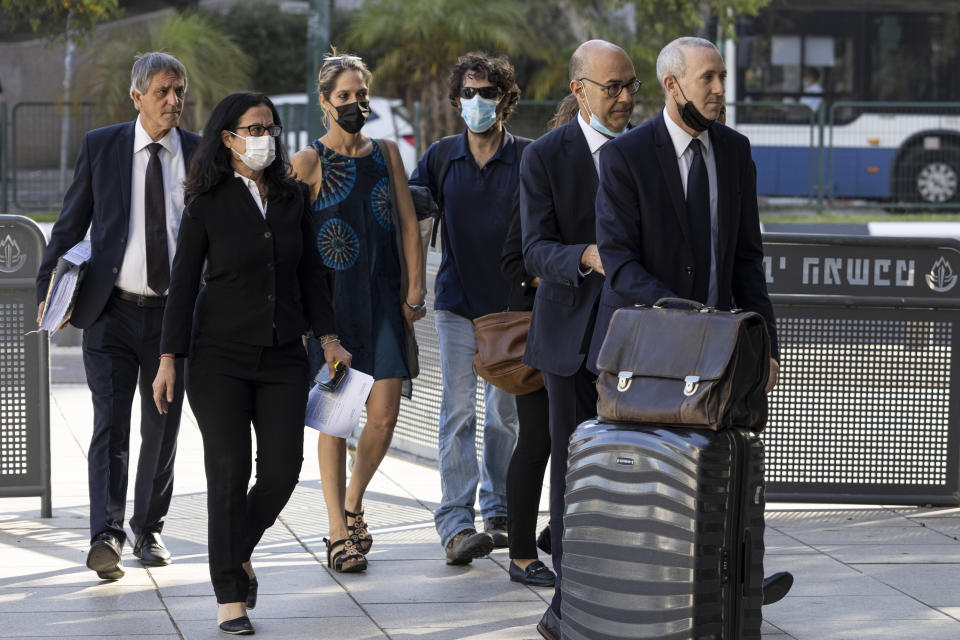 Aya Biran, third from left, a paternal aunt of Eitan Biran, who survived a cable car crash in Italy that killed his immediate family, arrives to court in Tel Aviv Friday, Oct. 8, 2021. The boy's parents and younger sibling were among 14 killed in May when a cable car slammed into a mountainside in northern Italy. He is now the focus of a custody battle between his maternal grandparents in Israel and his paternal relatives in Italy. (AP Photo/Tsafrir Abayov)