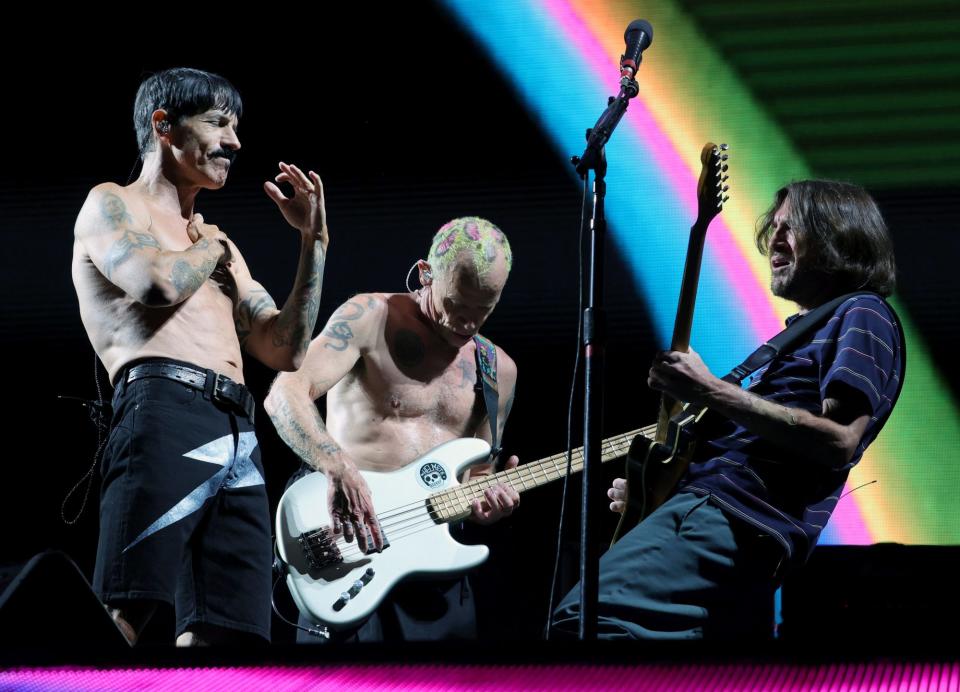 <p>Singer Anthony Kiedis, bassist Flea and guitarist John Frusciante of Red Hot Chili Peppers perform at Allegiant Stadium in Las Vegas on Aug. 6.</p>