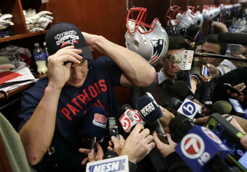 New England Patriots tight end Rob Gronkowski puts on a cap signifying his team's clinching of the AFC East title in 2014, one of the team's 11 straight division titles. (AP Photo/Charles Krupa)