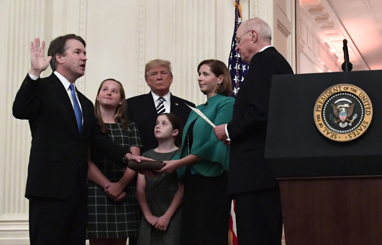 Brett Kavanaugh is ceremonially sworn in on Monday by retired Justice Anthony Kennedy, with Kavanaugh’s wife and daughters and President Trump looking on. (AP Photo/Susan Walsh)