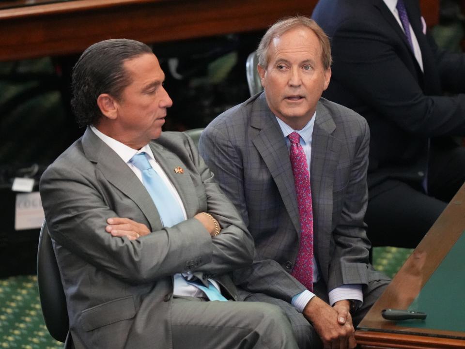 Attorney General Ken Paxton, right, waits with his attorney Tony Buzbee for closing arguments to begin Sept. 15 at his impeachment trial. In a new interview, Paxton railed against the Texas House for impeaching him.