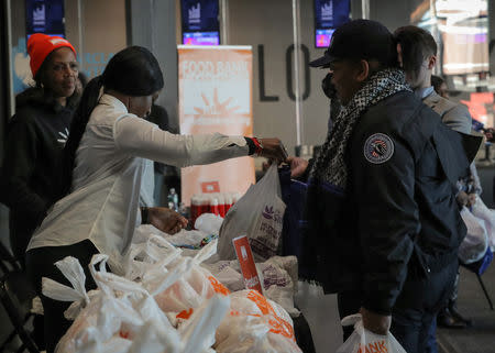 Transportation Security Administration (TSA) employees receive a donation at a food distribution center for federal workers impacted by the government shutdown, at the Barclays Center in the Brooklyn borough of New York, U.S., January 22, 2019. REUTERS/Brendan McDermid