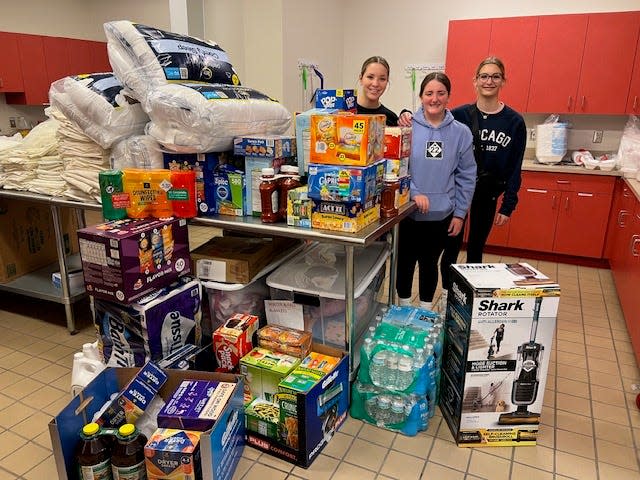 Bedford Junior High School honor students, Aubrey Kurek, left, Jasmine Philbeck and Isabella Brogan purchased items for the Ronald McDonald House Charities of Northwest Ohio.