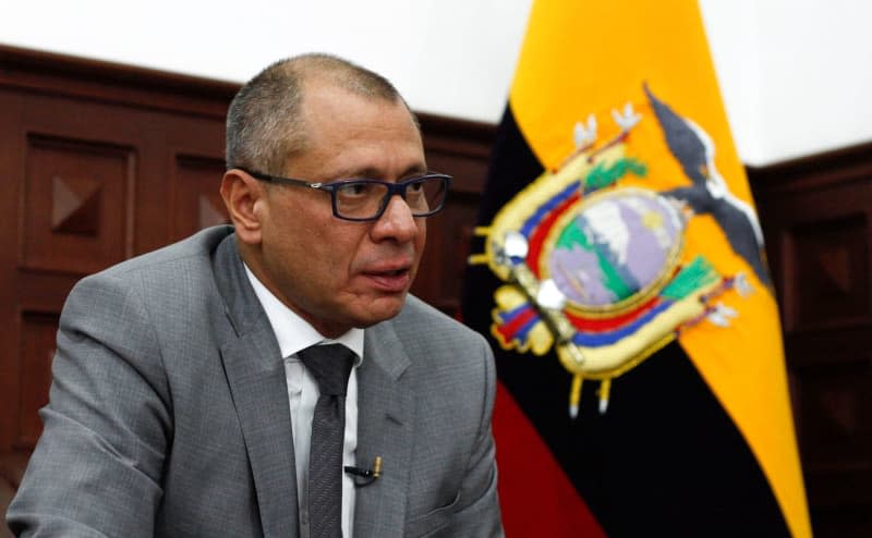The former Vice President of Ecuador, Jorge Glas, sits in front of the national flag in his office. Daniel Tapia/dpa