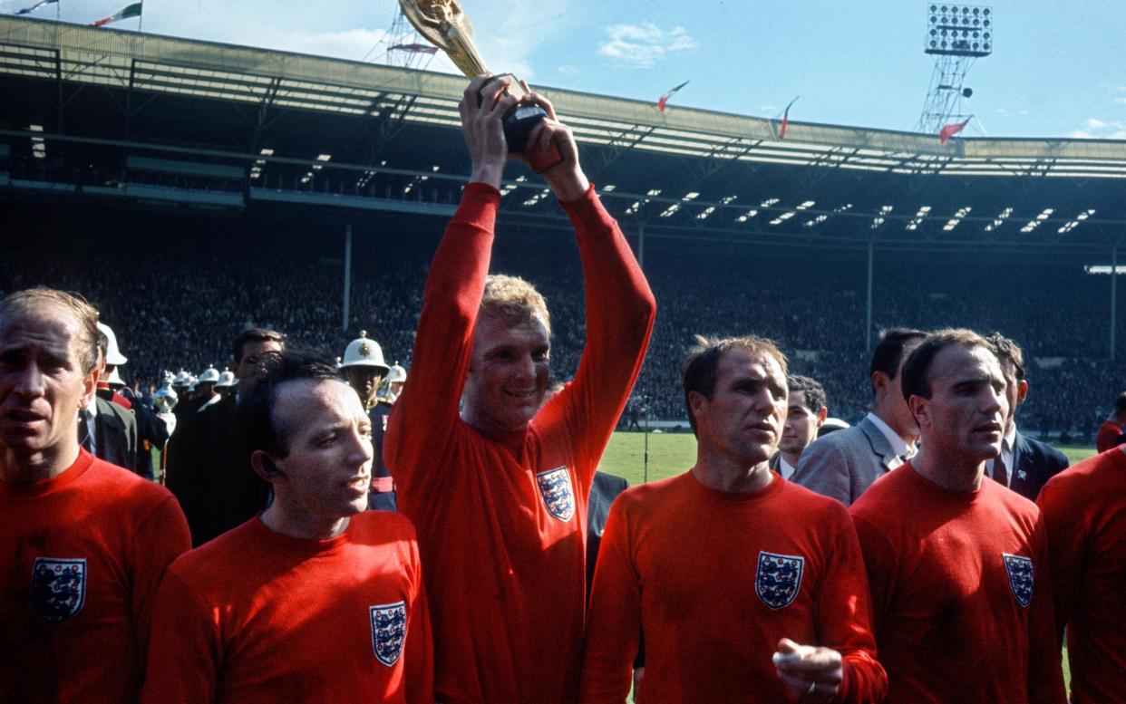 England captain Bobby Moore holds the Jules Rimet trophy aloft surrounded by Bobby Charlton, Nobby Stiles, Ray Wilson and George Cohen. - GETTY IMAGES