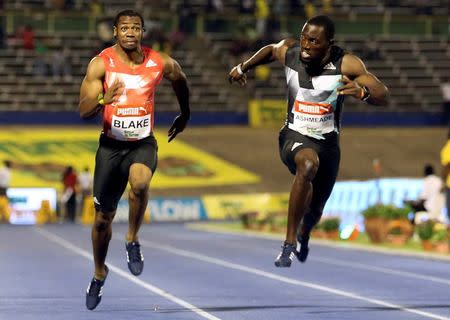 Athletics - Jamaica National Trials - Kingston - 01/07/16 Winner Yohan Blake (L) and Nickel Ashmeade in action during men's 100m final race. REUTERS/Gilbert Bellamy